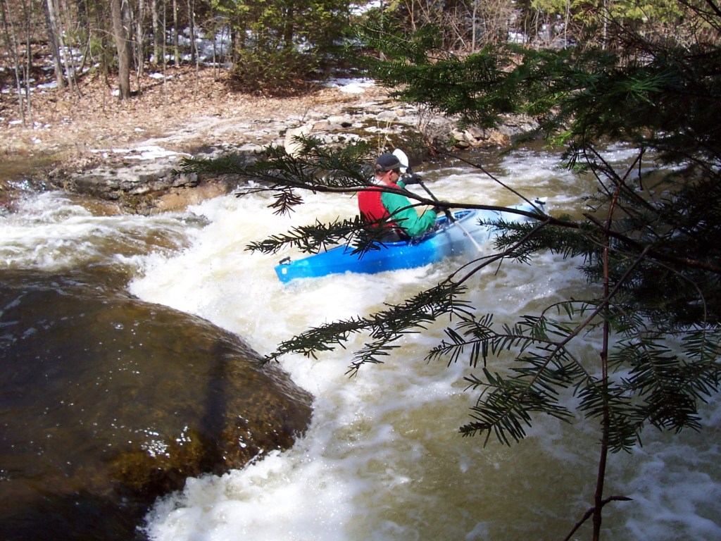 Kayaking over Chipmunk Falls on the Ocqueoc River in Northern Michigan.
