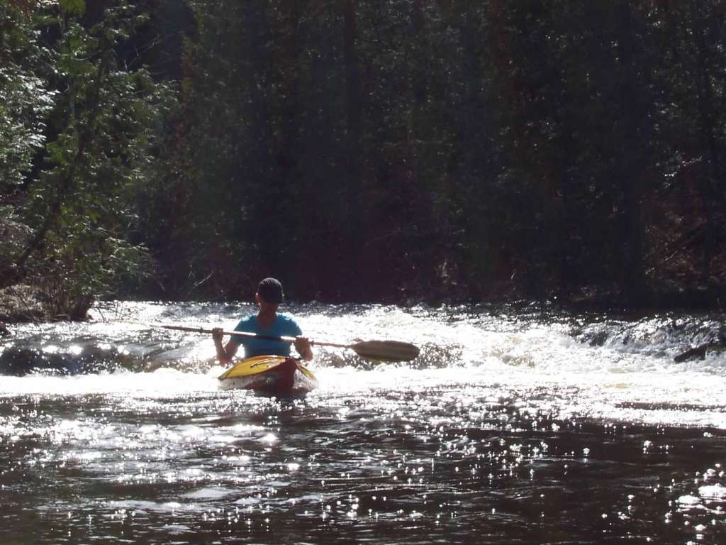 Kayaking through sparkling rapids on the Ocqueoc River in Northern Lower Michigan. 