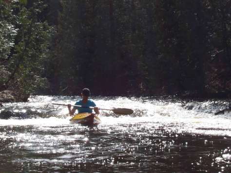 Kayaking through sparkling rapids on Michigan's Ocqueoc River.