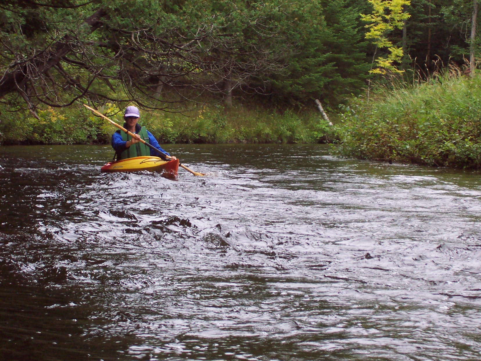 Paddling through the Crocket Bridge Rapids on the Black River in Northern Lower Michigan. 